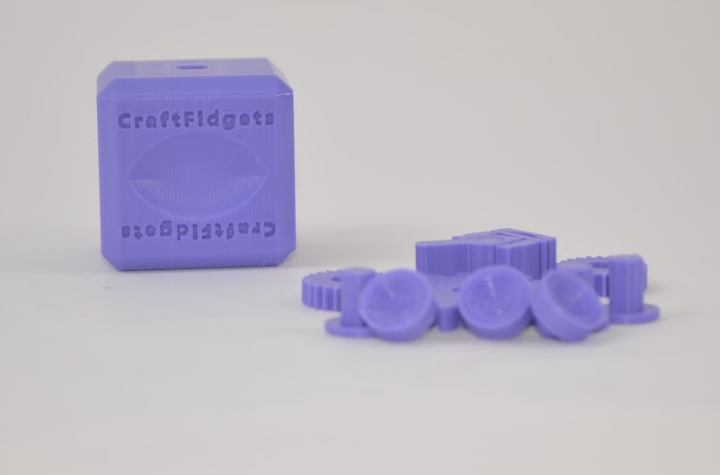 Purple CraftFidgets cube with interchangeable pieces